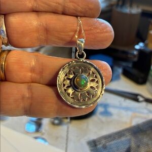 Beautiful opal in a circular sterling silver disc, comes with  925 chain